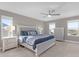 Main bedroom with king-size bed, nightstands, and ceiling fan at 1150 Blarney St, Minneola, FL 34715