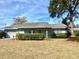 Ranch-style home with carport and mature landscaping at 1344 Cr 437, Lake Panasoffkee, FL 33538