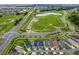 Aerial view of homes and landscape with nearby roadways at 1658 Galloway Dr, The Villages, FL 32163