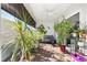 Bright and airy screened porch filled with various plants and a comfortable seating area at 1658 Galloway Dr, The Villages, FL 32163