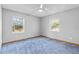 Spacious bedroom with blue carpet and two windows at 17469 Sw 35Th Avenue Rd, Ocala, FL 34473