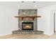 Stone fireplace with a wood mantel in the living room at 17469 Sw 35Th Avenue Rd, Ocala, FL 34473