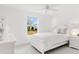 Charming bedroom with a white bed frame and large window overlooking backyard at 2051 Palo Alto Ave, The Villages, FL 32159