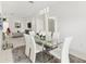 Elegant dining room featuring a glass table and white leather chairs at 2051 Palo Alto Ave, The Villages, FL 32159