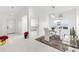 Bright dining room with glass table and white chairs, offering an open view to the kitchen at 2051 Palo Alto Ave, The Villages, FL 32159