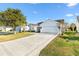Front view of a single story home with a driveway and attached garage at 2051 Palo Alto Ave, The Villages, FL 32159