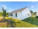 Rear view of a single story home with a well maintained lawn at 2051 Palo Alto Ave, The Villages, FL 32159