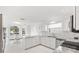 Modern white kitchen with granite countertops and stainless steel appliances at 2051 Palo Alto Ave, The Villages, FL 32159