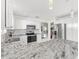 Modern kitchen with granite countertops and stainless steel appliances at 2051 Palo Alto Ave, The Villages, FL 32159