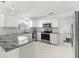 Modern kitchen with white cabinets, granite counters, and stainless steel appliances at 2051 Palo Alto Ave, The Villages, FL 32159