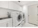 Clean laundry room with washer, dryer, cabinets, and a utility sink at 2051 Palo Alto Ave, The Villages, FL 32159