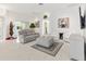 Relaxing living room with gray sectional sofa and white accent chairs at 2051 Palo Alto Ave, The Villages, FL 32159