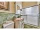 Bathroom features a shower/tub combo and green tile at 214 S Woodland St, Winter Garden, FL 34787