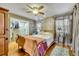 Bedroom with wooden sleigh bed, walk-in closet, and ceiling fan at 214 S Woodland St, Winter Garden, FL 34787