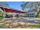 Carport with additional parking area, offering covered parking and storage at 214 S Woodland St, Winter Garden, FL 34787