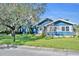 Blue house with white shutters and a welcoming front porch, nestled on a spacious lot at 214 S Woodland St, Winter Garden, FL 34787
