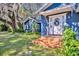 Inviting front entrance of a charming blue house with a terracotta tiled walkway at 214 S Woodland St, Winter Garden, FL 34787