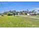 Landscaped yard with a long driveway leading to the house at 214 S Woodland St, Winter Garden, FL 34787