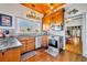 L-shaped kitchen with wood cabinets, stainless steel appliances, and a view to the dining room at 214 S Woodland St, Winter Garden, FL 34787