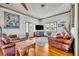Bright living room features hardwood floors, large windows, and leather sofas at 214 S Woodland St, Winter Garden, FL 34787