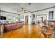 Open living room showcasing hardwood floors, leather furniture, and views into the dining area at 214 S Woodland St, Winter Garden, FL 34787