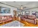 Spacious living room with hardwood floors and comfy leather sofas at 214 S Woodland St, Winter Garden, FL 34787