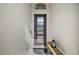Bright entryway with modern door, wood bench, and lantern at 2154 Wallingford Loop, Mount Dora, FL 32757