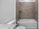 Clean bathroom with a tub and shower combination and modern tile at 40630 E Eighth Ave, Umatilla, FL 32784