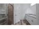 Modern bathroom with granite countertops, white cabinets, and a walk-in shower at 40630 E Eighth Ave, Umatilla, FL 32784