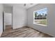 Spacious bedroom with wood-look flooring and large window at 40630 E Eighth Ave, Umatilla, FL 32784