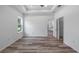 Bright bedroom with wood-look floors, recessed lighting, and a large closet at 40630 E Eighth Ave, Umatilla, FL 32784