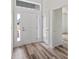 Bright and airy entryway with wood-look flooring and ample natural light at 40630 E Eighth Ave, Umatilla, FL 32784
