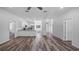 Open living room with vinyl plank flooring and kitchen island at 40630 E Eighth Ave, Umatilla, FL 32784