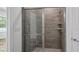 Walk-in shower with neutral tile and glass enclosure at 40630 E Eighth Ave, Umatilla, FL 32784