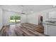 Open living space with wood-look floors, kitchen, and bathroom views at 40712 E Ninth Ave, Umatilla, FL 32784