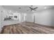 Open concept living area with kitchen island and wood-look floors at 40712 E Ninth Ave, Umatilla, FL 32784