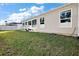 Large backyard with grassy area and home's exterior at 4414 Cameo Cir, The Villages, FL 32163