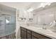Bathroom with double vanity, marble countertop, and a large walk-in shower at 4414 Cameo Cir, The Villages, FL 32163