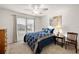 Bright bedroom with a queen-size bed, window, and ceiling fan at 4414 Cameo Cir, The Villages, FL 32163