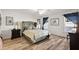 Guest bedroom with a large bed, hardwood floors, and window with curtains at 4414 Cameo Cir, The Villages, FL 32163