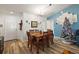 Bright dining room with wooden table and chairs, hardwood floors, and decorative wall art at 4414 Cameo Cir, The Villages, FL 32163