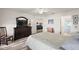 Main bedroom with dresser, large bed, and access to the bathroom at 4414 Cameo Cir, The Villages, FL 32163