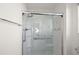 Walk-in shower with glass enclosure, grab bars, and modern fixtures at 4414 Cameo Cir, The Villages, FL 32163