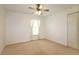 Well-lit bedroom with carpet and ceiling fan at 5107 Aurora Dr, Leesburg, FL 34748