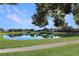 Peaceful community with a scenic pond and walking path at 5107 Aurora Dr, Leesburg, FL 34748