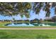 Serene community lake with homes and lush greenery at 5107 Aurora Dr, Leesburg, FL 34748