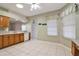 Kitchen with wood cabinets, white appliances, and tile flooring at 5107 Aurora Dr, Leesburg, FL 34748