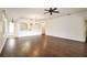 Large living room with dark hardwood floors and high ceilings at 5107 Aurora Dr, Leesburg, FL 34748