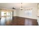 Spacious living room with dark hardwood floors and access to a lanai at 5107 Aurora Dr, Leesburg, FL 34748