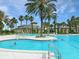 Resort-style pool with palm trees and lounge chairs at 5107 Aurora Dr, Leesburg, FL 34748